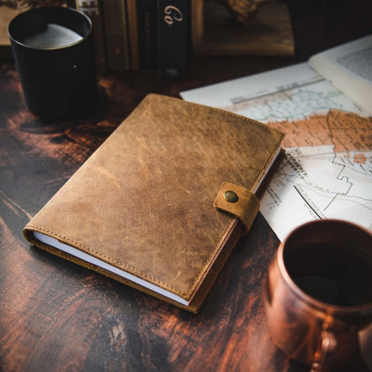 Leather journal showing brass button closure