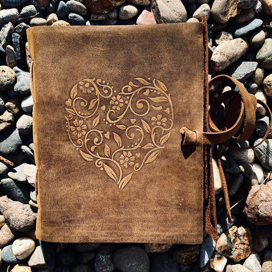 Heart leather journal open showing unlined pages