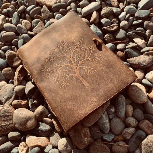 Tree of Life leather journal open showing unlined pages