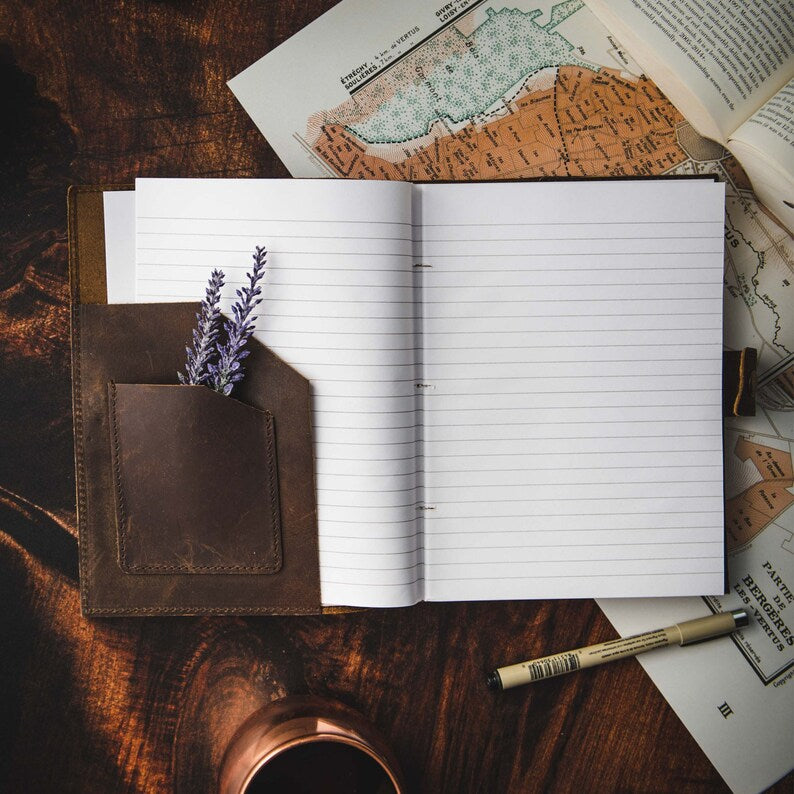 Leather journal being written in with fountain pen
