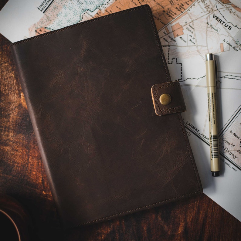 Refillable leather journal open showing lined pages