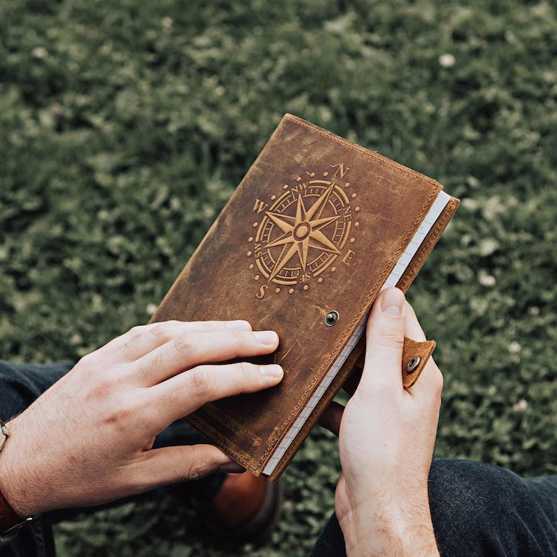 Leather travel journal on wooden surface
