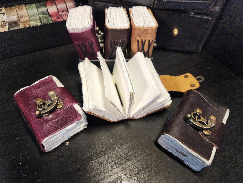Three dark mini leather journals spread out