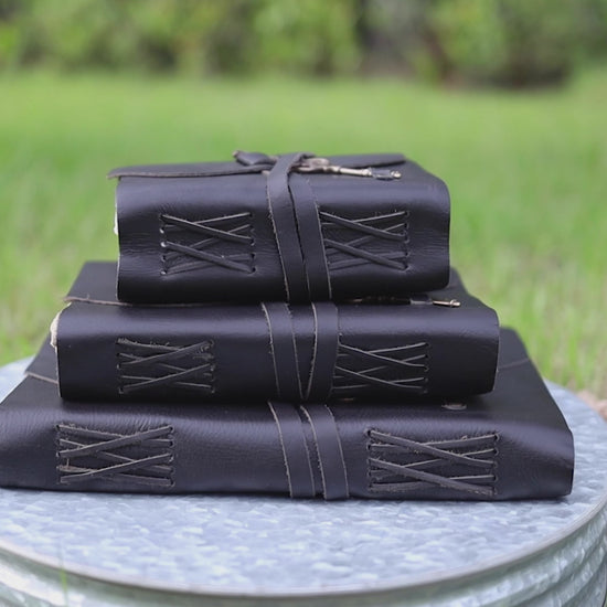 Black leather journal with antique brass key closure and handmade deckle edge pages