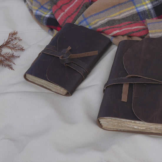 Brown vintage leather journal with lined deckle edge pages — page flip and cover detail