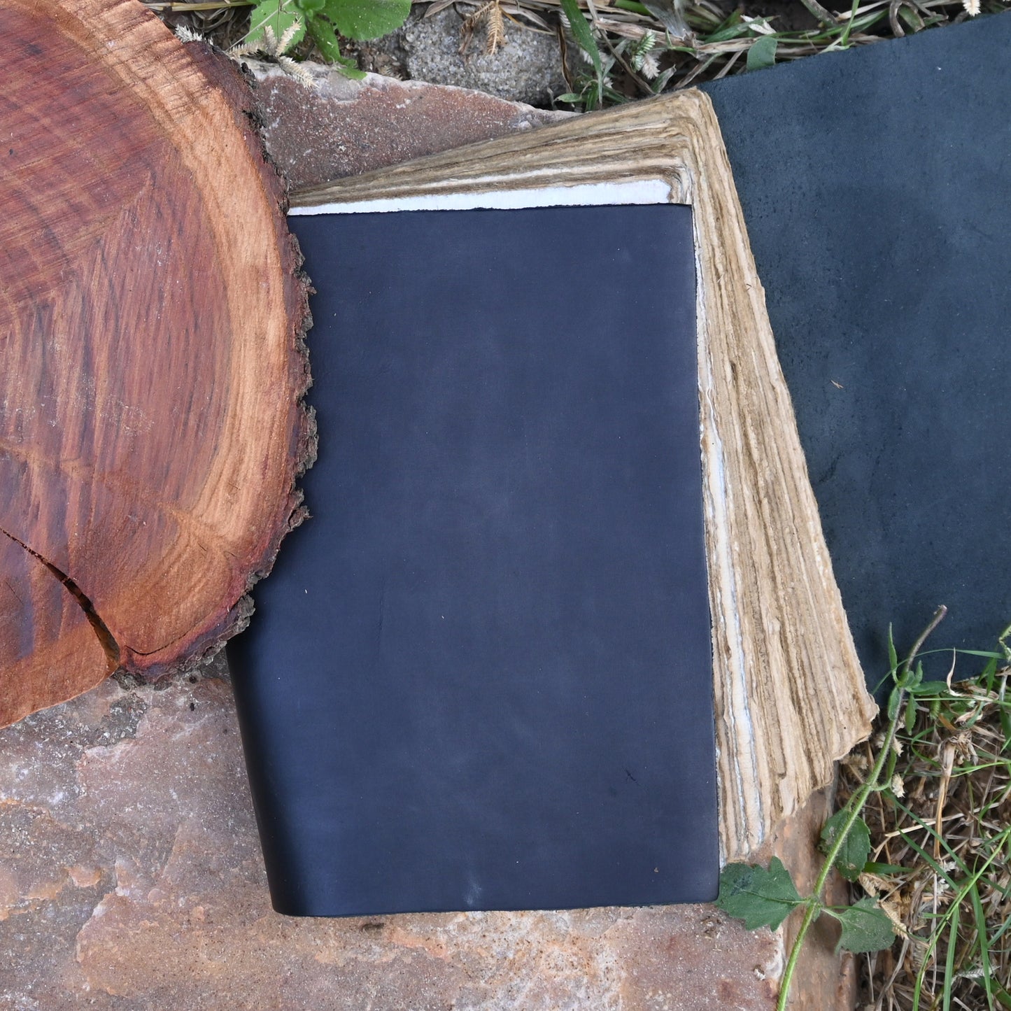 Black leather journal being written in
