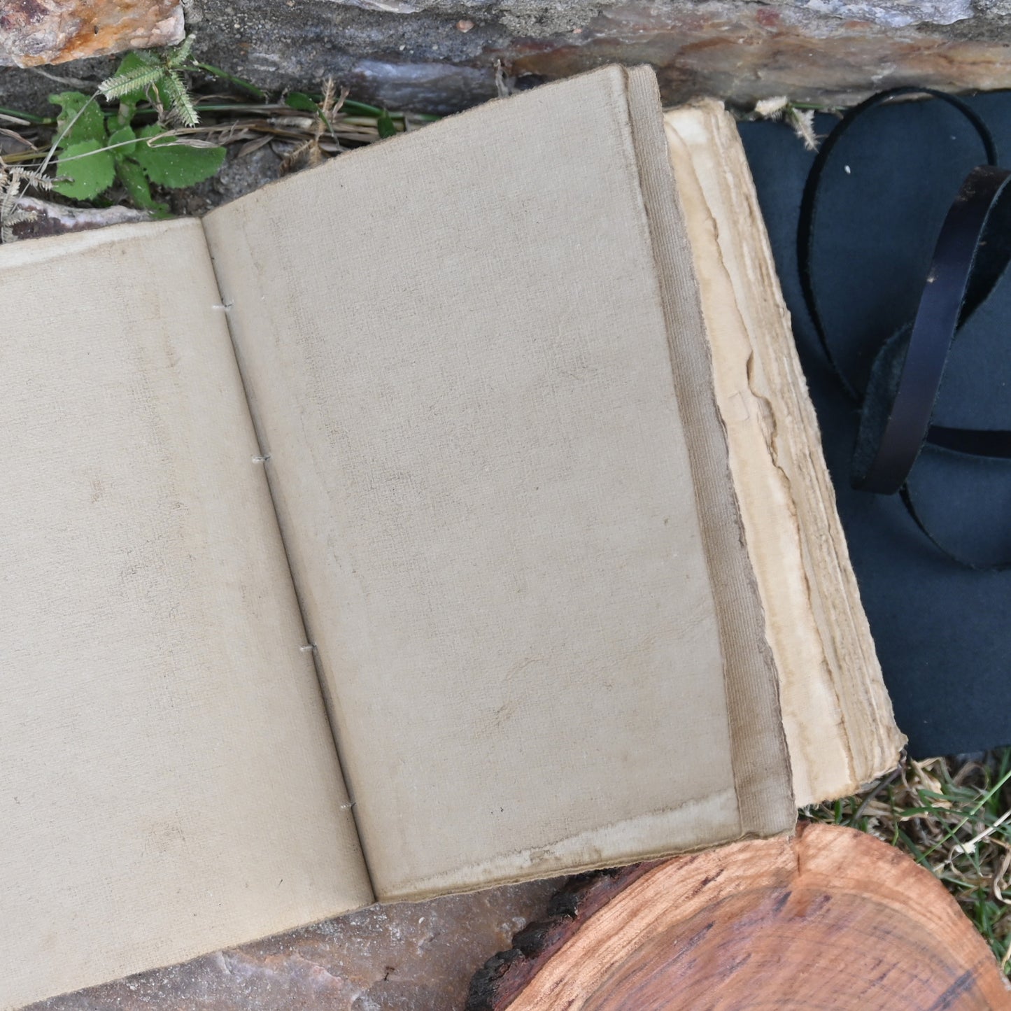 Black leather journal open showing deckle edge pages