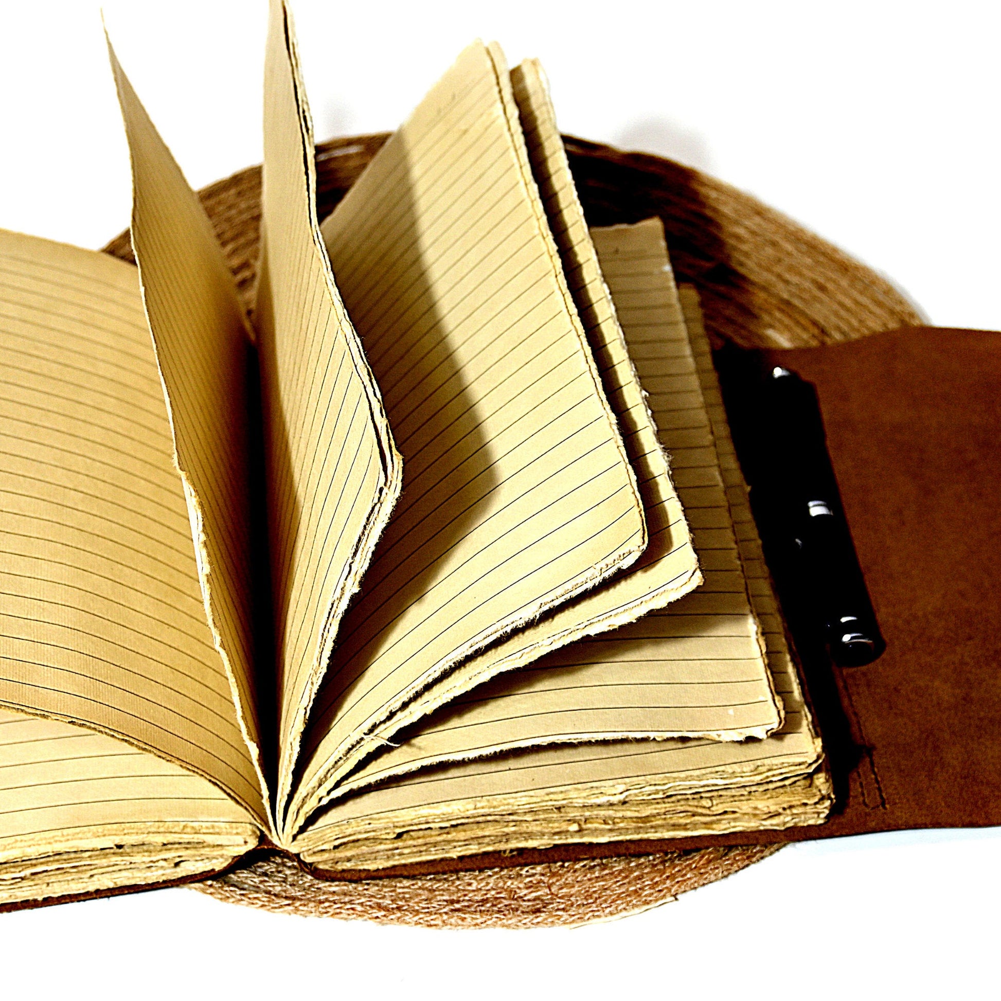 Brown leather journal open showing lined pages